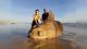 Two fishermen stand beside a giant sunfish