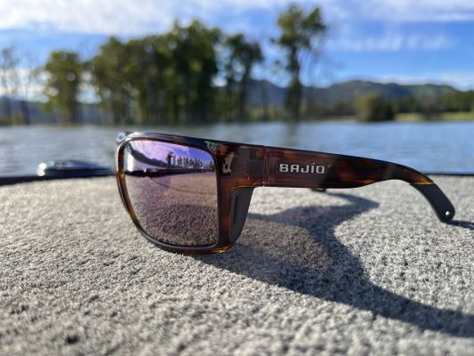 Lens Material and Color
For the most part, there are two choices for sunglass lens material: Glass or polycarbonate (plastic), and both have their benefits. Glass is slightly more expensive but has many fans for its clarity and scratch resistance. The drawback is that it is also somewhat heavier than polycarbonate, which is still very crisp. Either one is a good choice, and like most things, it will come down to your preference.
Lens color is where things get more specialized, as each lens color can change what you see under the surface. Some hues let in more light, which can be a good thing sometimes, and others block out more light, which can also benefit some fishing situations.
Baj&iacute;o offers seven main lens colors, each featuring its LAPIS technology, which blocks out 95 percent of blue light, most yellow light, and 100 percent UV light. The colors include blue mirror, green mirror, gray, silver mirror, copper, rose mirror, and violet mirror.
As a quick rundown of the lens colors, the blue mirror is excellent for bright situations such as offshore fishing, and the green mirror is better for shallow fishing because of its high-contrast nature. Gray is similar to the blue mirror as it is a darker lens, but it does not include the mirrored finish, so it has less flash. The silver mirror is a medium-light lens and versatile for shallow waters and offshore fishing, while copper is similar to the silver mirror but has more muted colors with high contrast.
A green mirror or silver mirror is an excellent all-around choice, but more specialized lenses exist. Two other unique choices are rose mirror, a technical lens that works great for shallow and deep-water fishing. It's a bright pink mirror with excellent contrast for scanning the shallows as you look for fish. Finally, there is violet mirror, a bright and high-contrast lens that is great for low-light conditions and sight fishing.
&nbsp;
&nbsp;