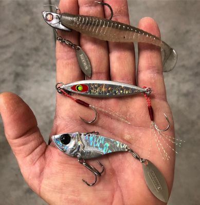 The Rest
Besides the underspin and Damiki Rig, Thrift likes to mix in a Damiki Vault Blade Bait, Axe Blade Tail Spinner, and Back Drop Jigging Spoon.
"The spoon is a great way to reach schooling fish," he says. "With 12-pound P-Line Tactical, I can cast it out of sight to reach them. I'll let it hit the water and then start reeling and it shimmies about a foot under the surface and looks just like a little shad. I can also drop it over brushpiles and let it hover above the cover."
The Vault blade bait and tail spinner are his other choices.
"The blade bait is a great fall bait and I fish it with a lift and drop retrieve," he says. "The tail spinner is another great choice when the fish are suspended."
As fall turns to winter, bass are feeding up and that often means chasing schools of shad. Finding the bait is the number one key, followed closely by matching the hatch.
