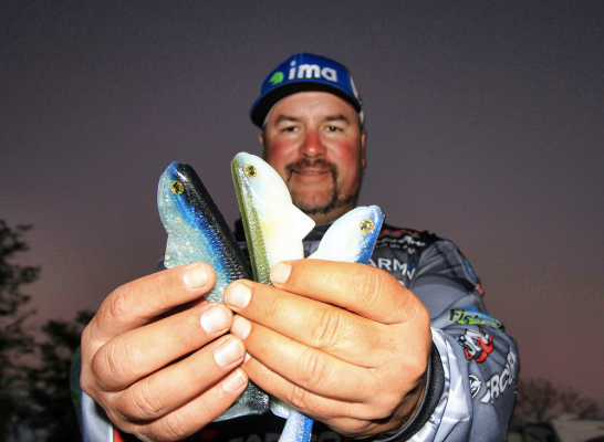Slow Rolling a Swimbait
Roumbanis would likely fish a swimbait every day if the fish wanted it and he&rsquo;s hoping it puts some fish in the boat for him at REDCREST. His signature series of Optimum Baits&nbsp;Boom Boom swimbaits come in several sizes and rigging options and he says they will be ideal for the standing timber and numerous docks along the lake.
&ldquo;I&rsquo;ll fish them up shallow around the docks, but also slow roll them a little deeper in the ditches and drains,&rdquo; he says. &ldquo;During my trip there, I spent a lot of time making my own map on my Garmin and found a lot of subtle areas that looked like nothing. I found some little channel swings and things like that and those spots that others overlook can be really good this time of year.&rdquo;
READ RELATED: Boom Boom Swimbait... Here's How It's Done
&nbsp;