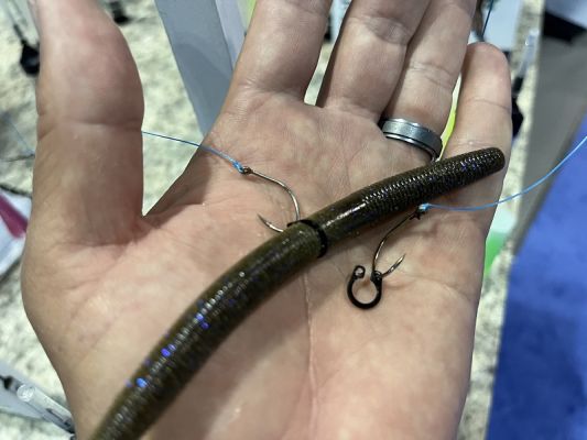 Terminal Tackle &ndash; Bambuie Bear Wacky Neko Clip
I&rsquo;m a sucker for a good piece of terminal tackle that solves a common issue and that&rsquo;s precisely what this little clip does. With the popularity of wacky and Neko rigging, tons of items on the market help you rig your soft plastic bait, from O-Rings and silicon sleeves and more.
This little clip is ingenious because of its simplicity, and it won&rsquo;t come off your hook because of the angled hook slots. Turn the clip slightly to insert the hook and then rotate it and then the barb of your hook can&rsquo;t come out. The plastic sits right inside the clip and the two hook holes are there to fit various hook sizes. Just pick the one that fits your hook. It&rsquo;s a simple little item but holds the bait just right. This company also has a unique scent injector, which is pretty neat. They appear focused on doing something different than what everyone else is producing.
&nbsp;
&nbsp;