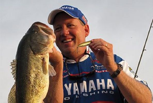 Alton Jones&nbsp;| Double Your Split Rings
Like his son, Jones, Sr. is a big fan of the clear colored Super Spook Jr.
&ldquo;It is the right size where you still get numbers of bites and still catch big ones. The clear color is what I use almost anytime the water is clear or calm,&rdquo; said Jones. &ldquo;The clear body hides the bait from them, and they don&rsquo;t get as good of a look at it, but you still get the tantalizing walk-the-dog action that the Spook is known for.&rdquo;
When fishing any of the varieties of Heddon&rsquo;s Spooks, he often adds a second split ring to increase his chances of landing fish.
&ldquo;I take off the hook and then add a second split ring. It does two things, it lowers the hooks further into the water and reduces leverage,&rdquo; Jones said. &ldquo;The fish can shake their head but can&rsquo;t shake the lure as easily. This is especially important when fishing for smallmouth or spotted bass.&rdquo;
READ RELATED: Small Swimbaits for Summer Bass with Alton Jones