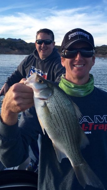 Derrick holding the big fish of the day a fat white bass caught on a small swimbait