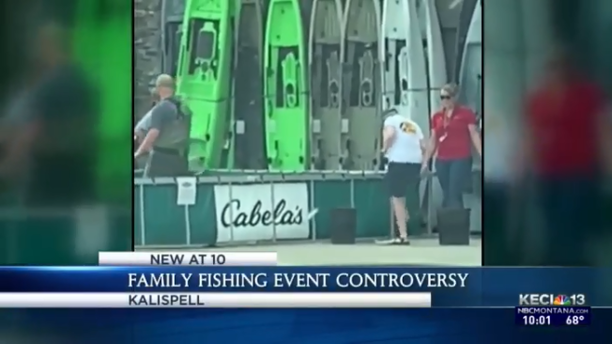 workers killing fish at Cabela's fishing event.png