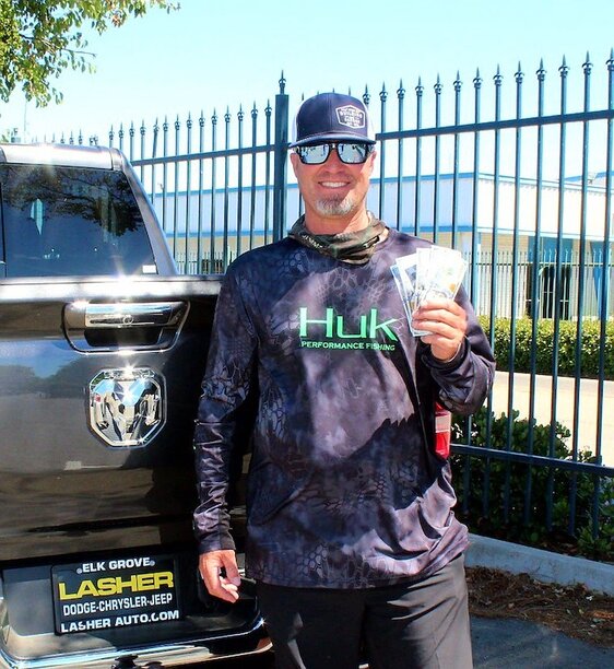 John Cunningham is all smiles holding up &quot;Trickle Down&quot; cash he received for 20th out of the money!