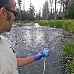 Dr. Shaun Clements, research scientist for the Oregon Department of Fish and Wildlife, tests the waters of the upper Deschutes River for environmental DNA. Scientists are now able to use eDNA to tell what species are present in aquatic populations. This technology will help reduce the cost of fish monitoring and provide an early warning if invasive species are present. (ODFW photo)